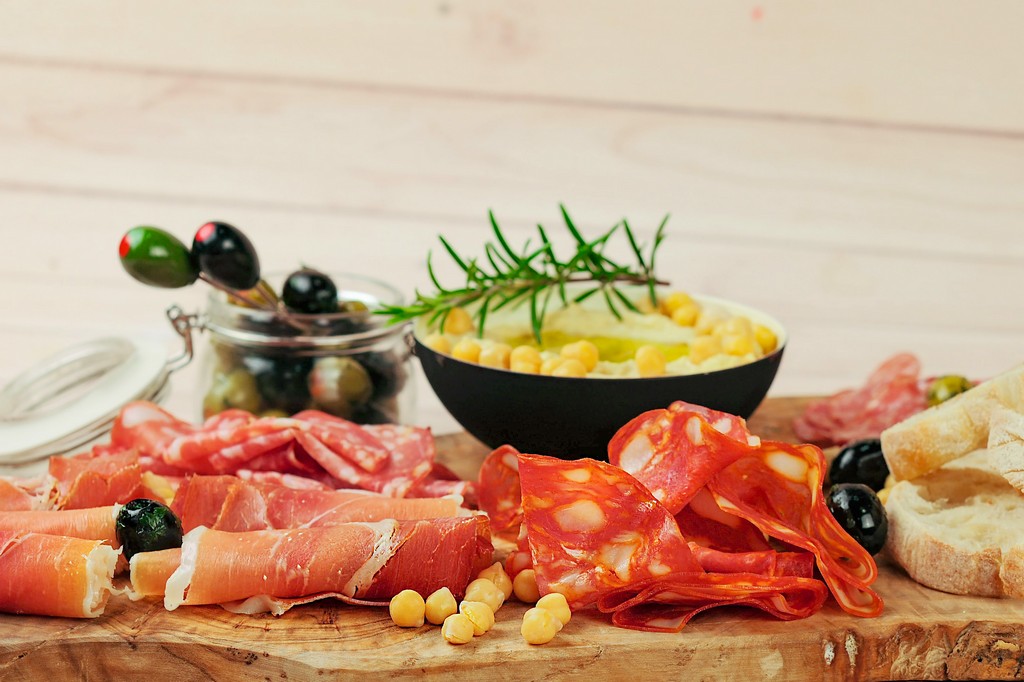 Antipasti board with hummus and olives